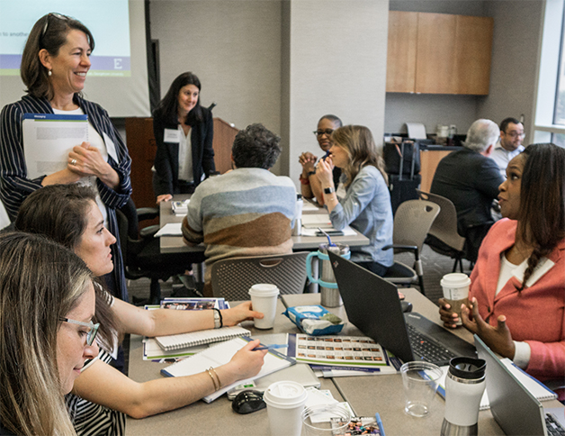 Attendees sitting at a table during a finance training