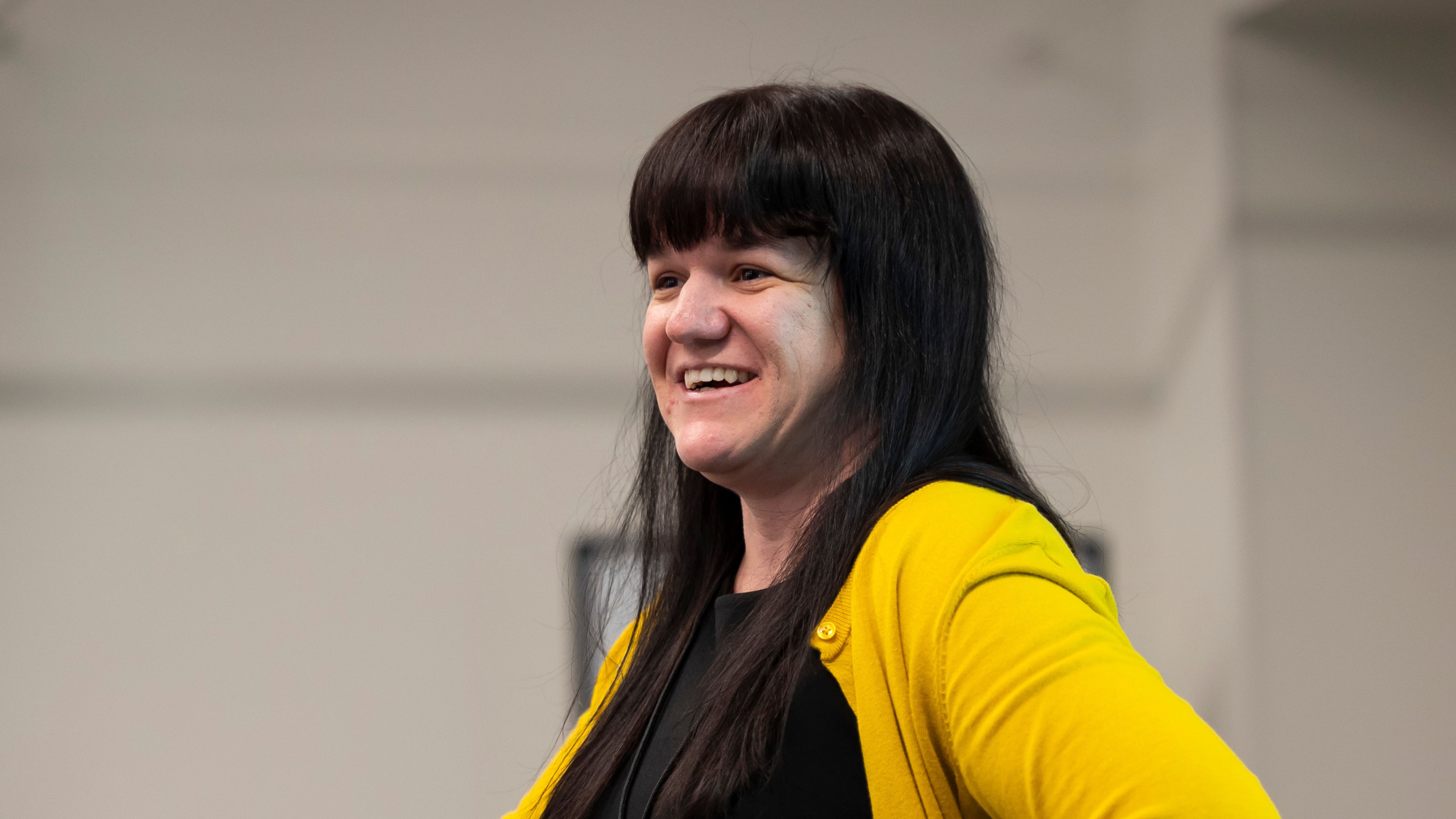 Jocelyn Franke smiles behind a podium