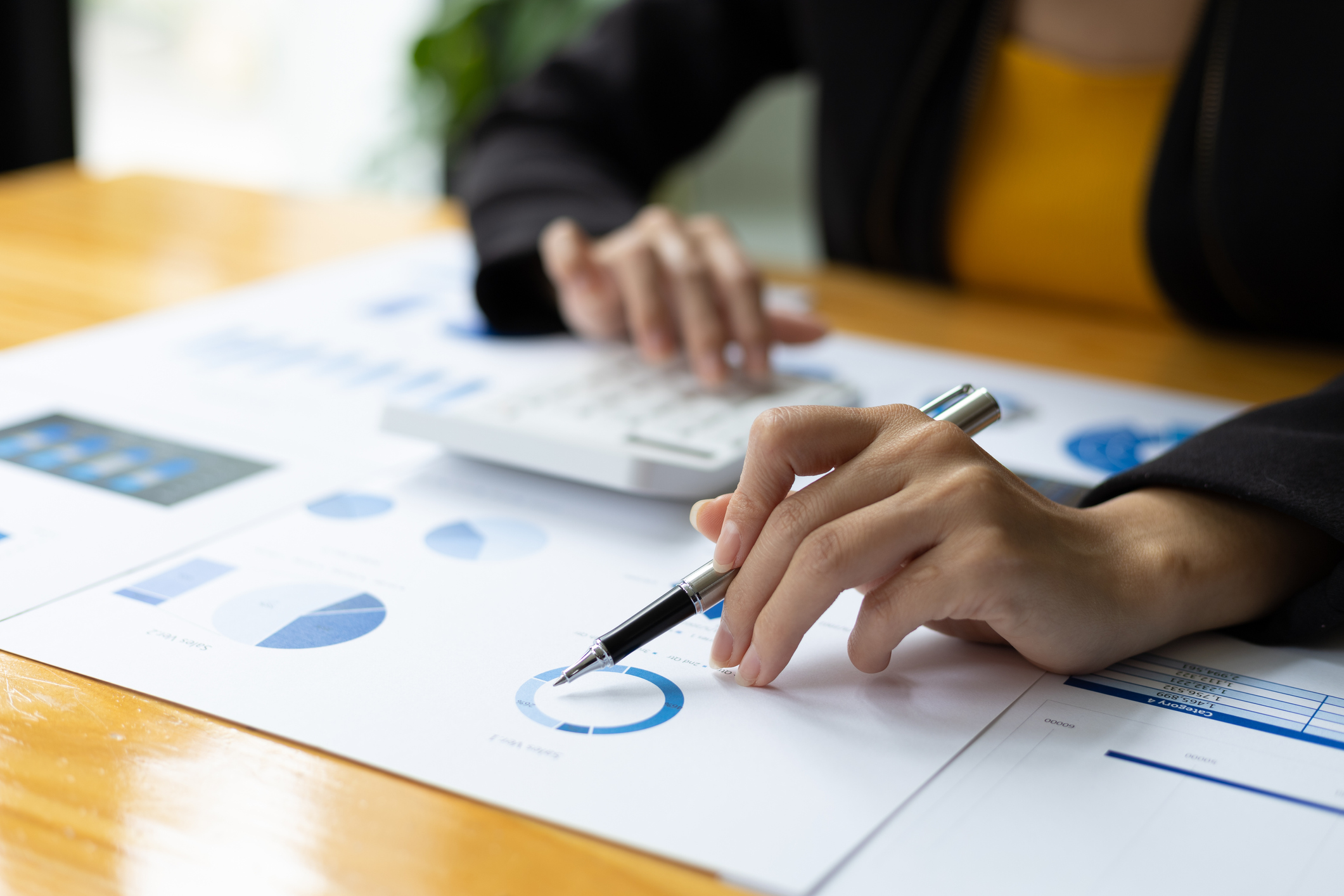 Person sitting at desk reviewing financial documents