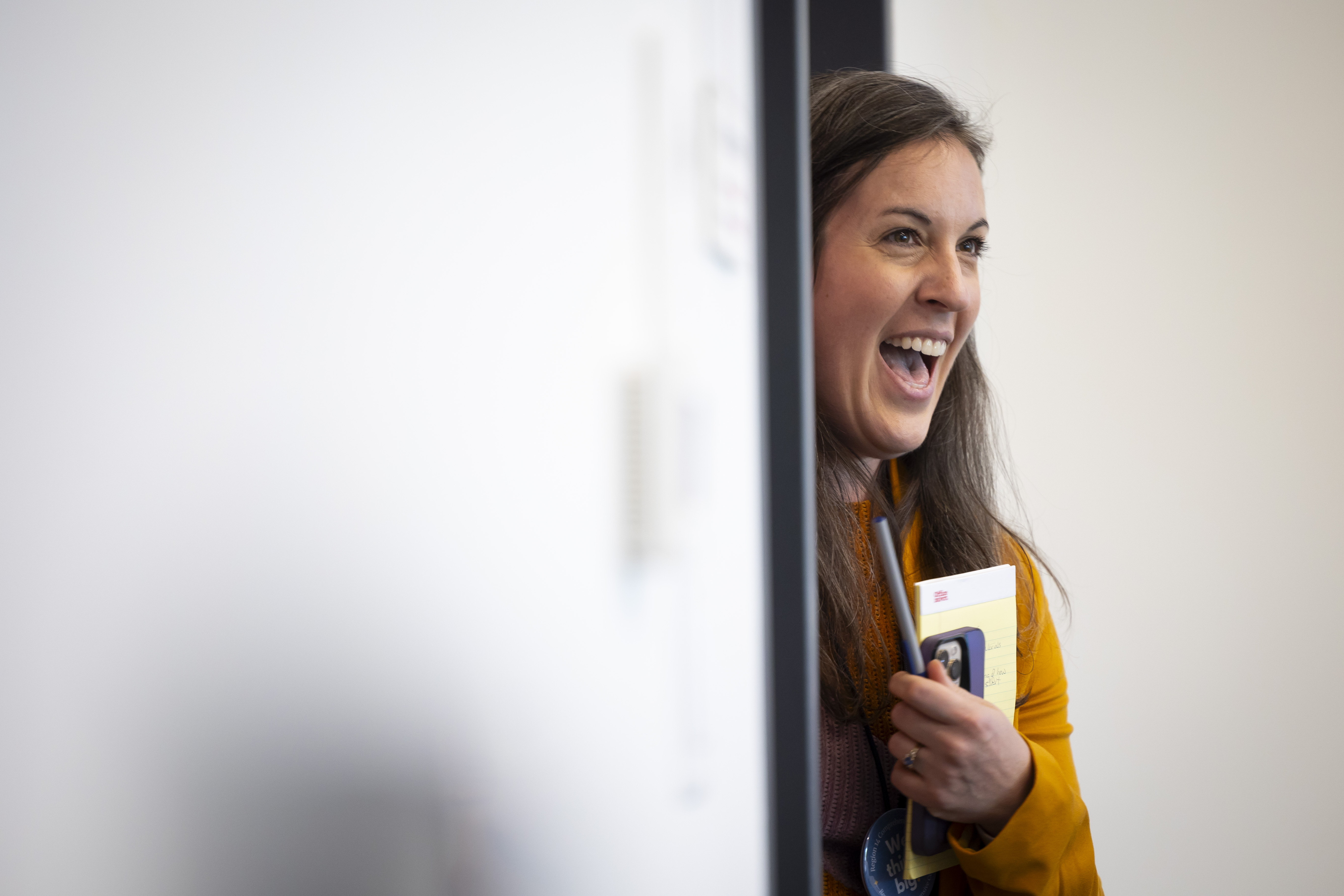 Sally Hall smiles from the doorway at an R14CC Advisory Board meeting