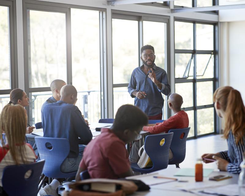 Leader talking to group of people in a meeting