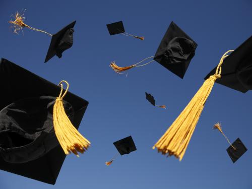 Graduation caps flying in the air
