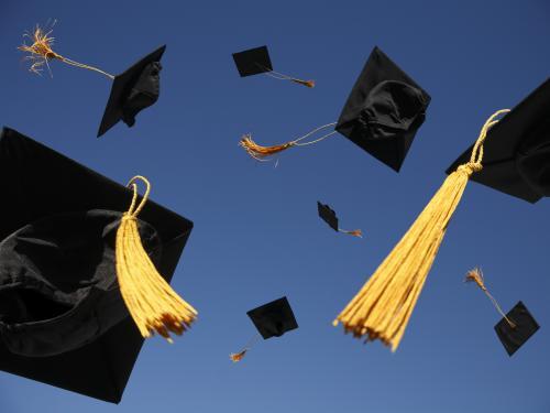 Graduation caps suspended in the air.